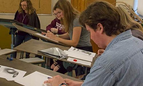 students in a drawing class