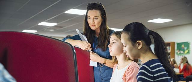 Teacher working with students